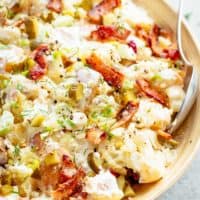 Potato Salad with Bacon, Dill Pickles, Eggs, HALF the carbs AND a creamy mayo/sour cream dressing! This Potato Salad is THE BEST side dish! HALF of the carbs of regular potato salads with SO MUCH FLAVOUR! The recipe also includes LOW CARB AND ALL CARB OPTIONS! | cafedelites.com