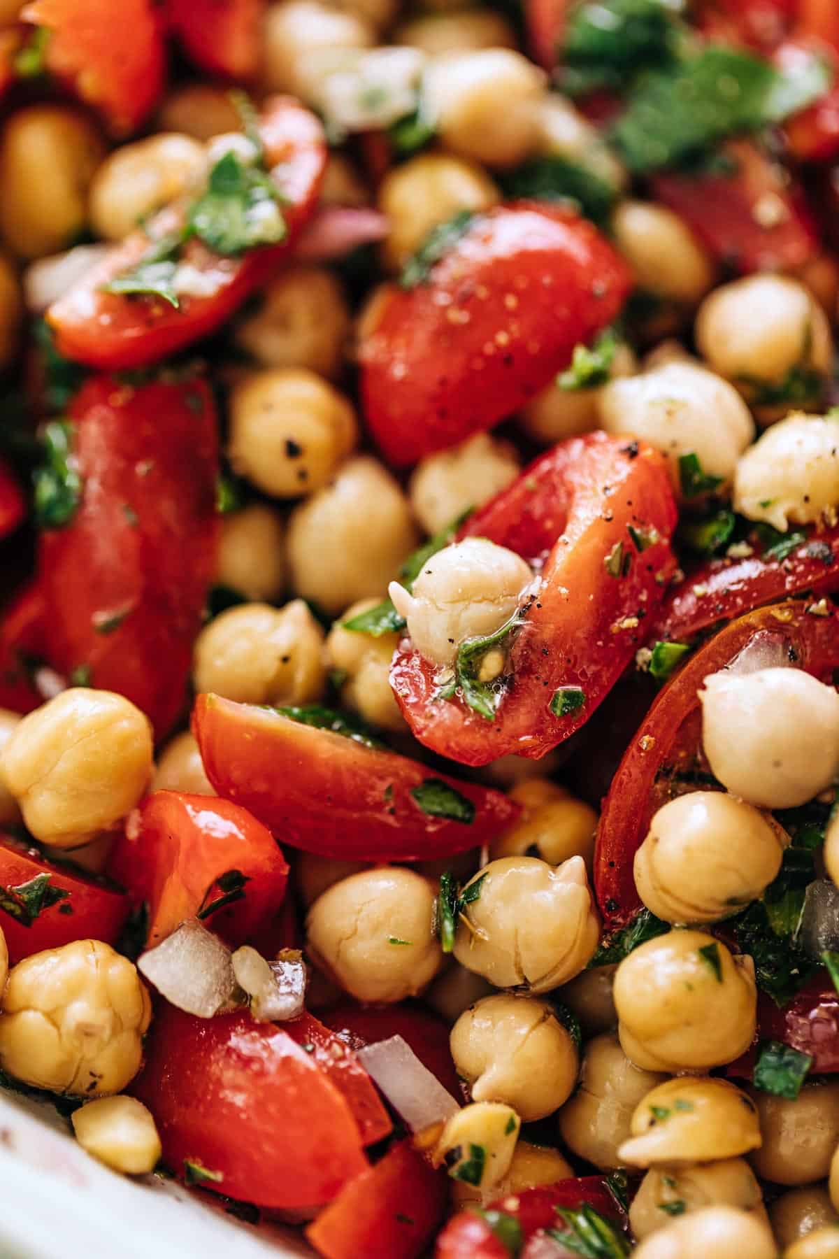 A close up image of a bowl of Chickpea Tomato Salad | cafedelites