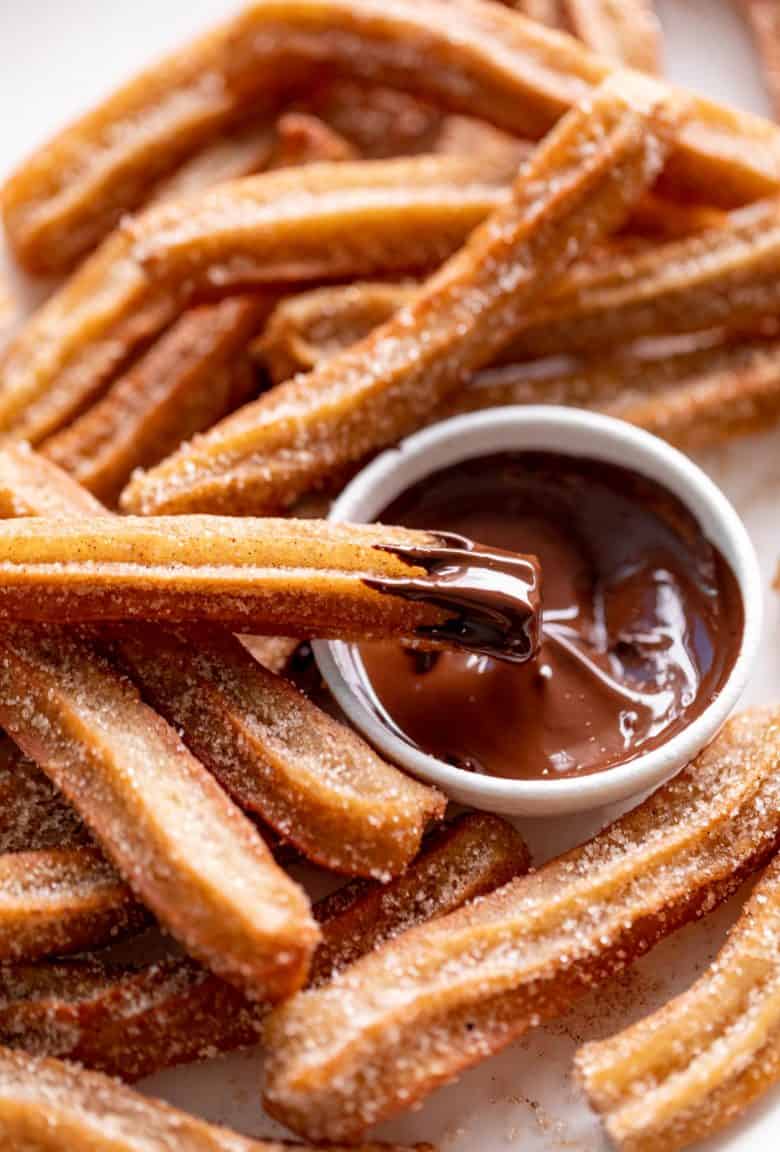 Churros dipped in chocolate sauce | cafedelites.com
