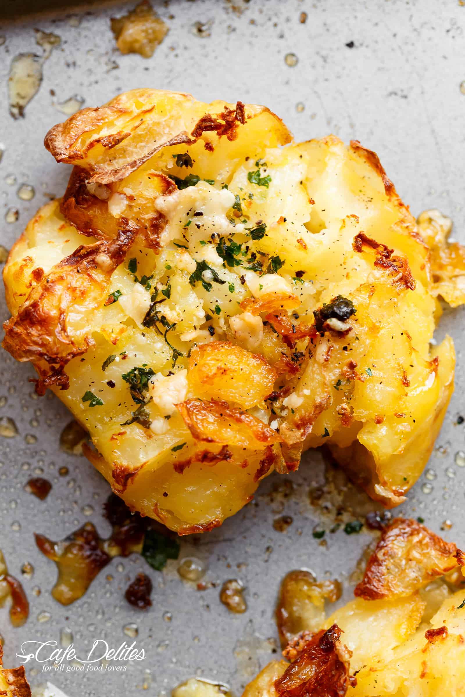 Crispy Garlic Butter Parmesan Smashed Potatoes with crispy edges that will send you over the edge! | http://cafedelites.com