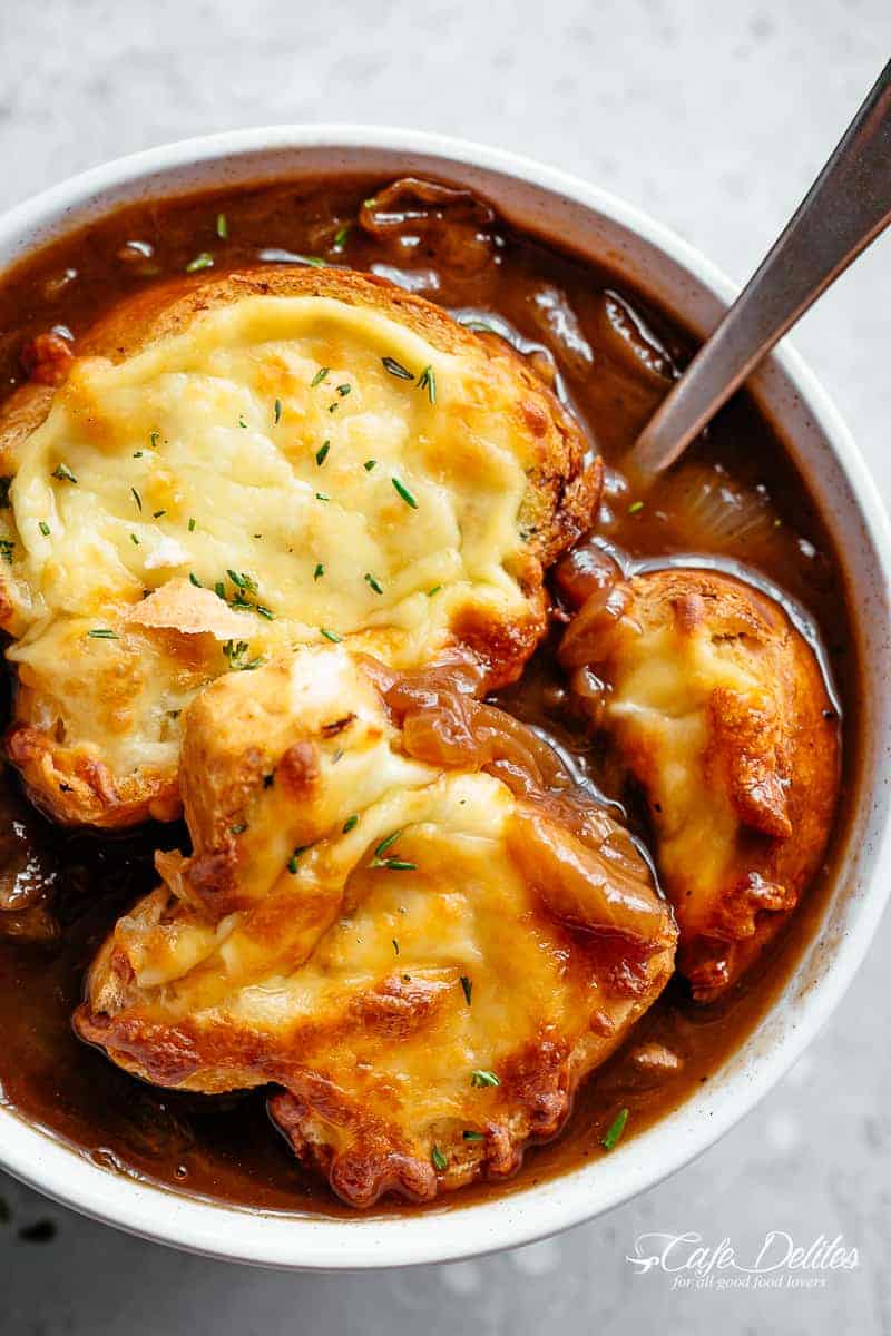 Classic French Onion Soup finished off with garlic bread and two types of melted cheese | cafedelites.com