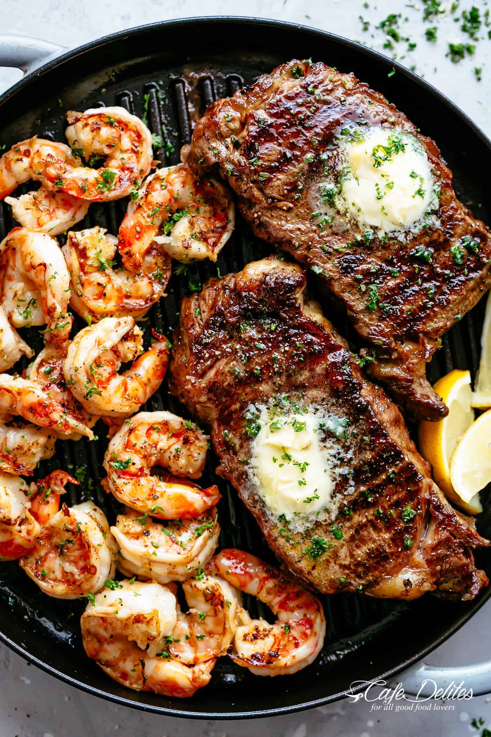 Grilled Steak & Shrimp slathered in garlic butter makes for the BEST steak recipe! A gourmet steak dinner that tastes like something out of a restaurant, ready and on the table in less than 15 minutes | cafedelites.com