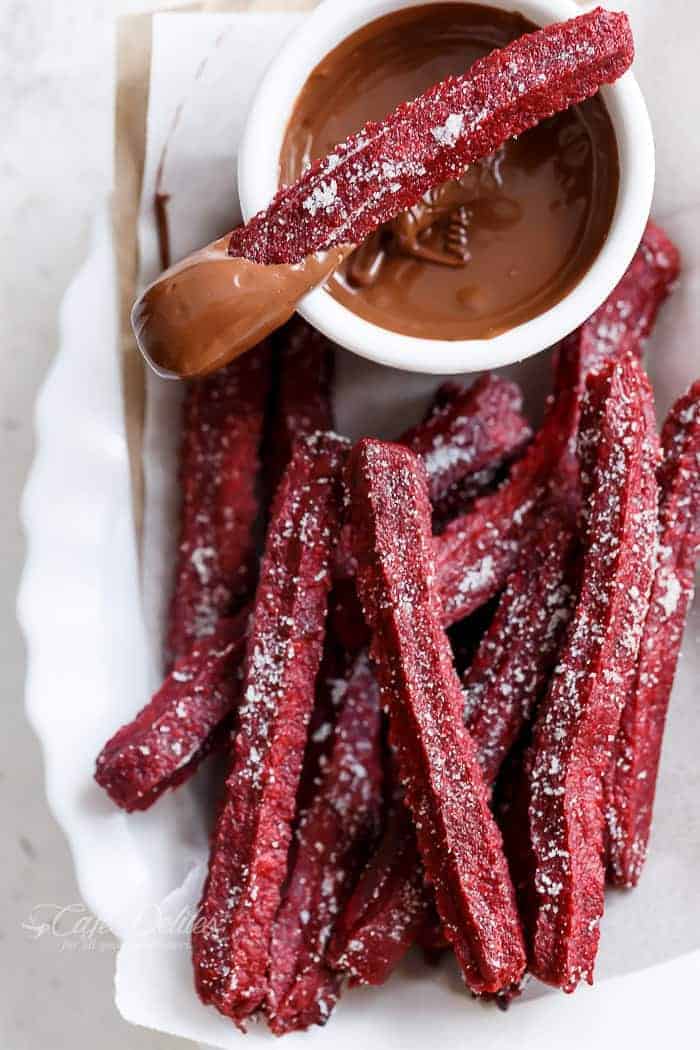 The Best Red Velvet Churros... now you can make them at home with a Red Velvet Twist! Just like store-bought Churros. BUT BAKED not fried and only 36 calories EACH! | https://cafedelites.com