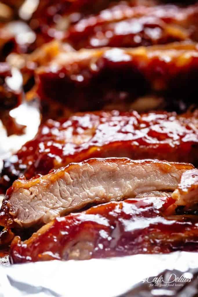 Slow Cooker Ribs slathered in the most delicious sticky barbecue sauce with a kick of garlic and optional heat! Juicy melt-in-your-mouth oven baked Barbecue Pork Ribs are fall-off-the-bone delicious! Double up on incredible flavour with an easy to make dry rub first, then coat them in a seasoned barbecue sauce mixture so addictive you won't stop at one! Finger licking good ribs right here! | cafedelites.com
