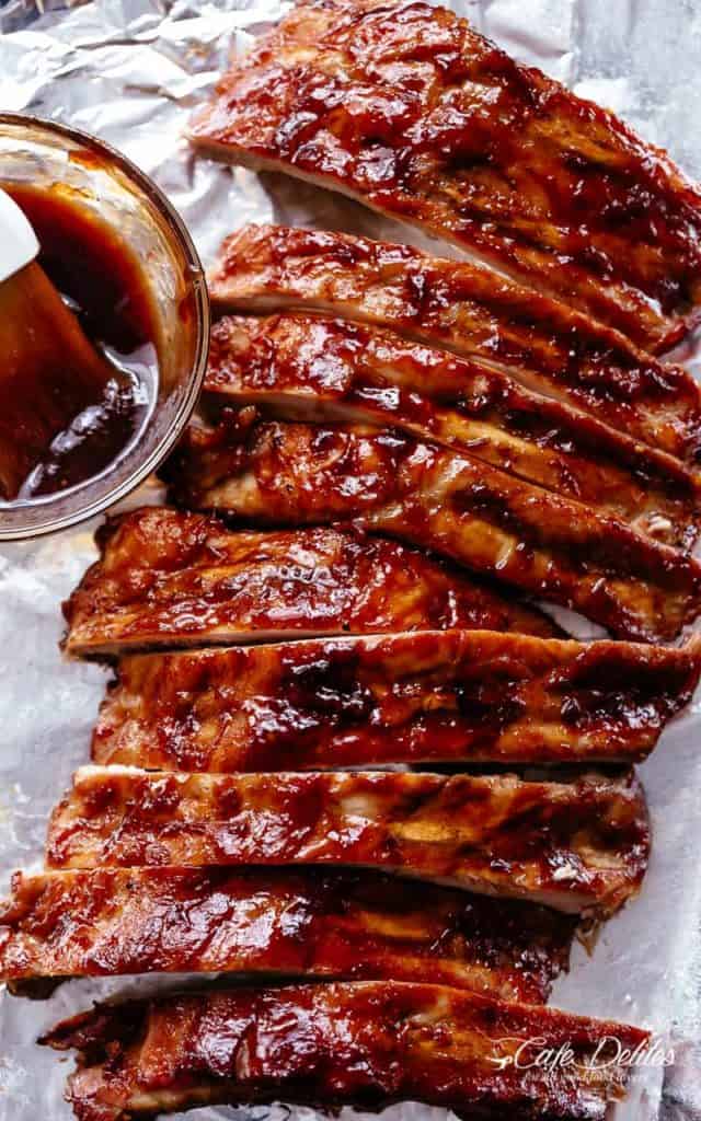Crock Pot Ribs slathered in the most delicious sticky barbecue sauce with a kick of garlic and optional heat! Juicy melt-in-your-mouth oven baked Barbecue Pork Ribs are fall-off-the-bone delicious! Double up on incredible flavour with an easy to make dry rub first, then coat them in a seasoned barbecue sauce mixture so addictive you won't stop at one! Finger licking good ribs right here! | cafedelites.com