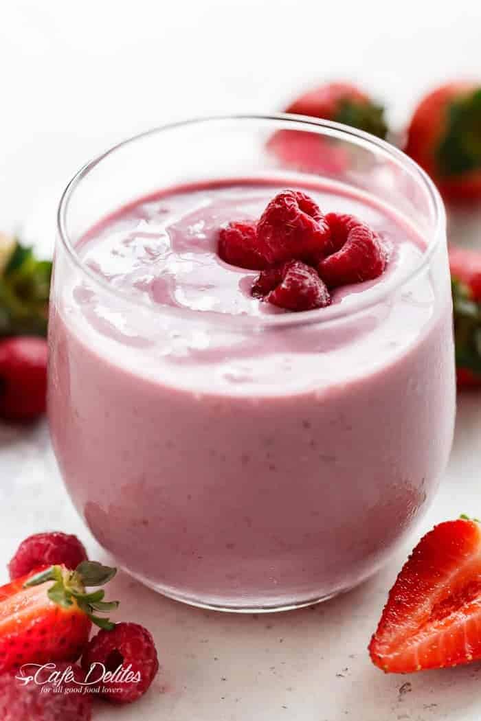 A thick, super creamy and filling Strawberry-Raspberry Oatmeal Cheesecake Smoothie that tastes exactly like a cheesecake....in a glass....for breakfast! | https://cafedelites.com